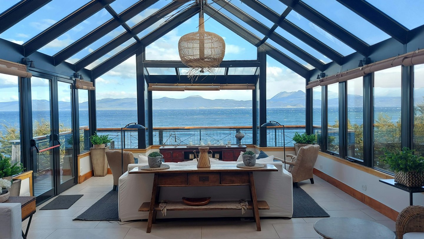 Sunroom with sea views and comfortable seating.